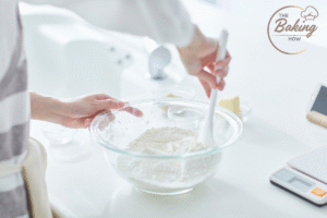 All-purpose flour in a bowl on a digital kitchen scale for baking cookies.