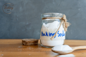 Baking soda and baking powder jars as leavening agents for cookies.
