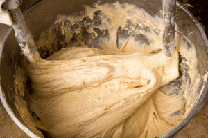 Overmixed dough in stand mixer showing gluten development