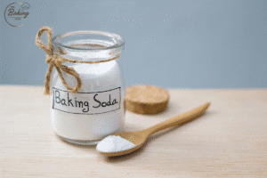 Baking powder and baking soda containers, representing how leavening agents affect cookie texture.